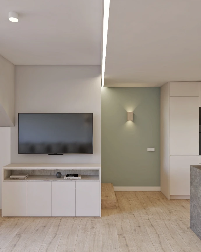 Zona de TV con mueble a medida y pared decorativa en vivienda reformada