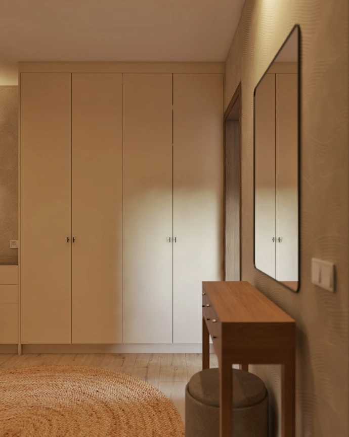 Pasillo con iluminación integrada y acabados cálidos en proyecto de interiorismo